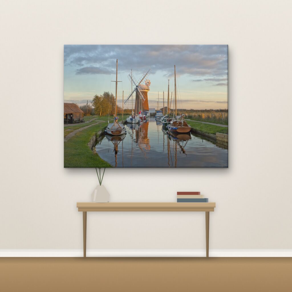 A landscape photo printed on canvas, hanging above a console table